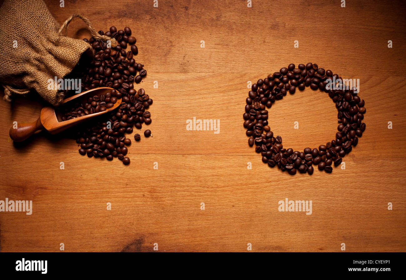 Metal coffee maker and a pattern of coffee beans in the shape of a circle  on a gray background with Stock Photo by Artjazz