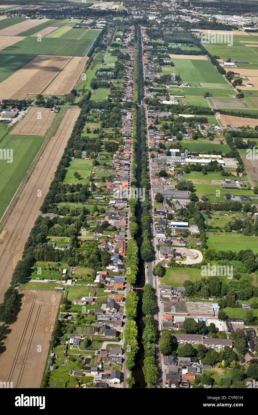 The Netherlands, Musselkanaal. Houses and businesses at both sides of canal. Aerial. Stock Photo