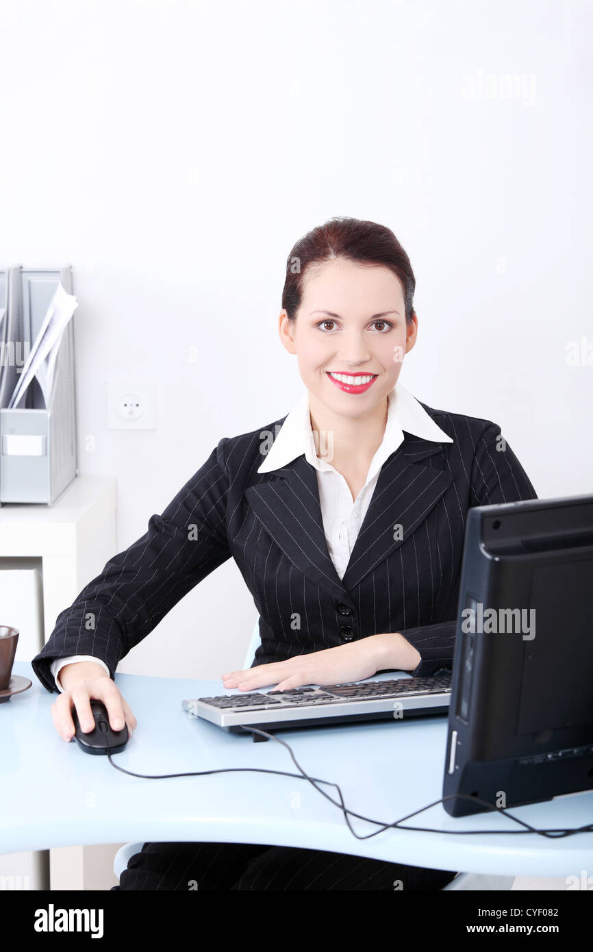 Front view portrait of a beautiful young smiling business woman sitting ...