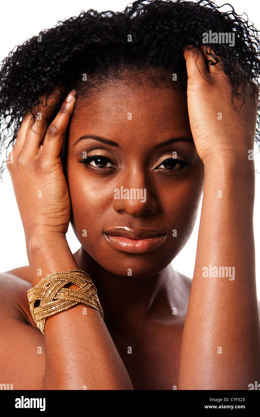 Face of a beautiful African woman with great skin holding hands in curly  hair and bracelet around arm isolated Stock Photo  Alamy
