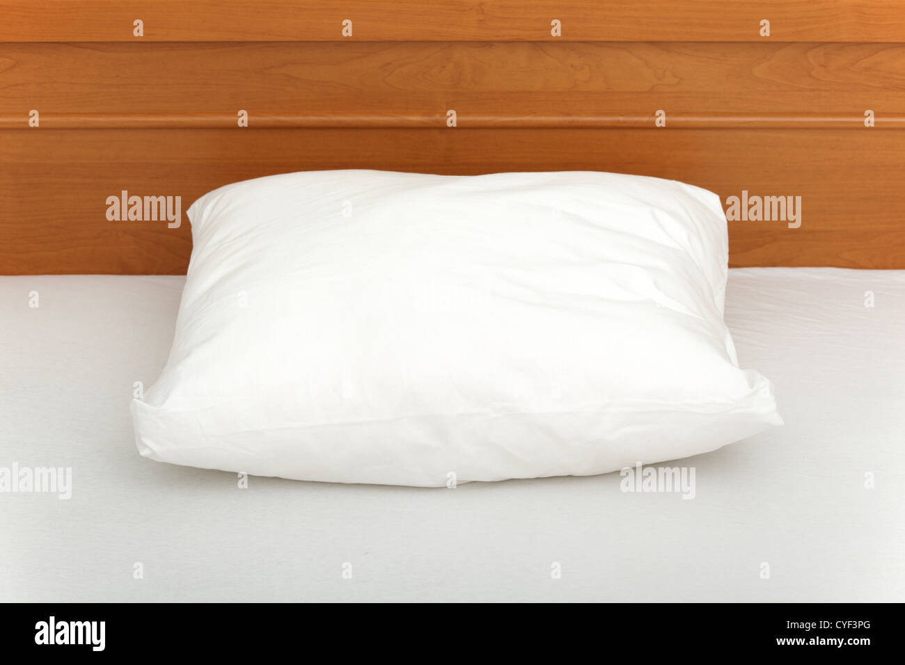 Picture of a pillow lying in an empty bed. Stock Photo