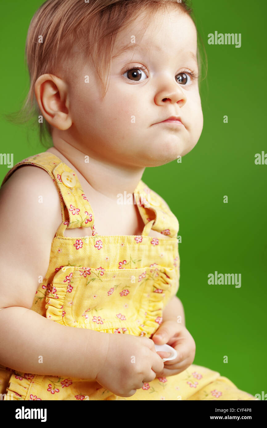 Cute baby on studio green background Stock Photo