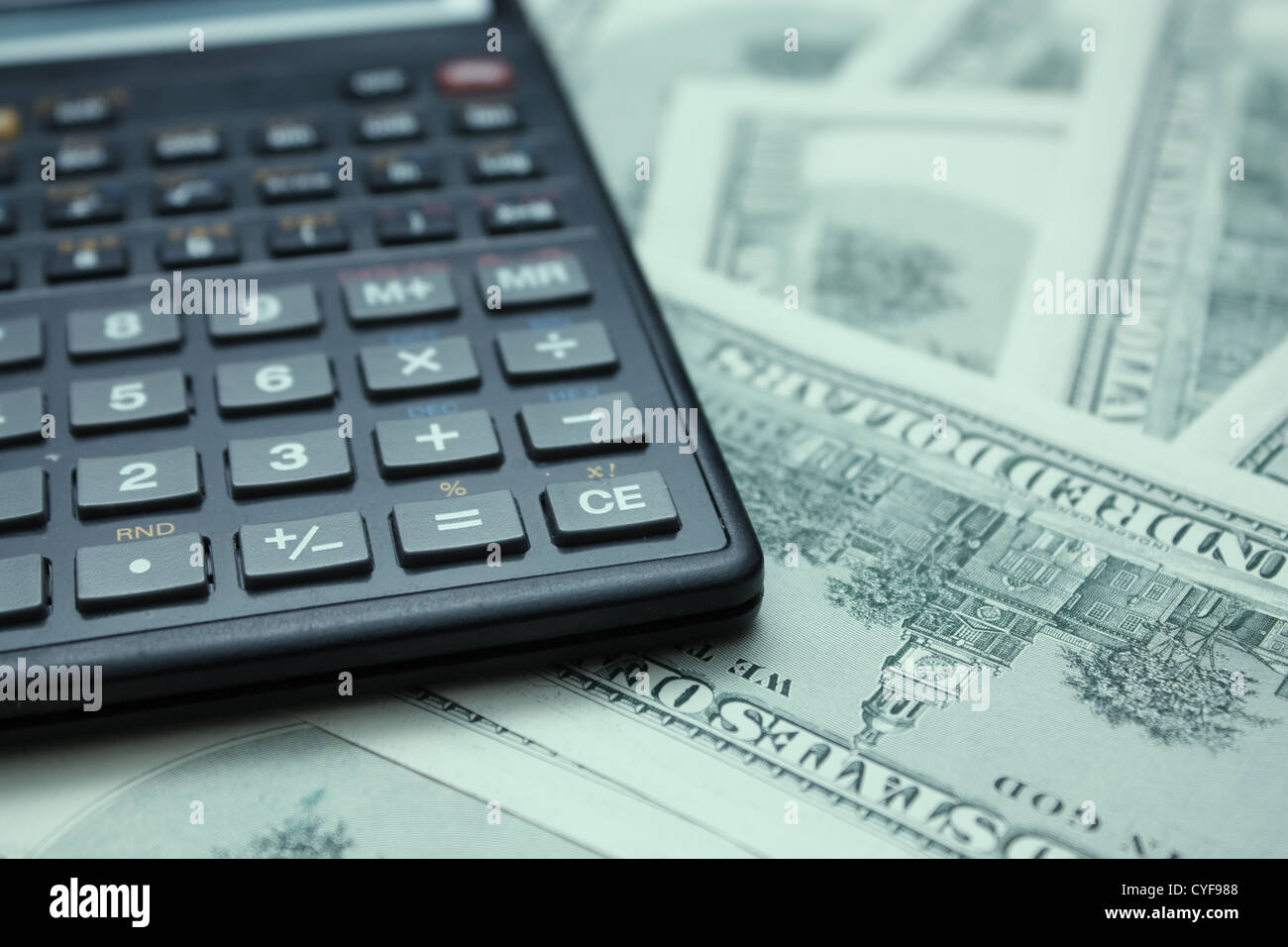 dollars with calculator with interest focus. Stock Photo