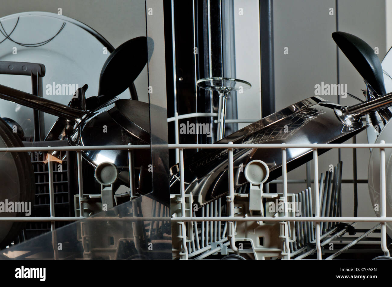 Dishwasher full of dishes next to stove Stock Photo Alamy