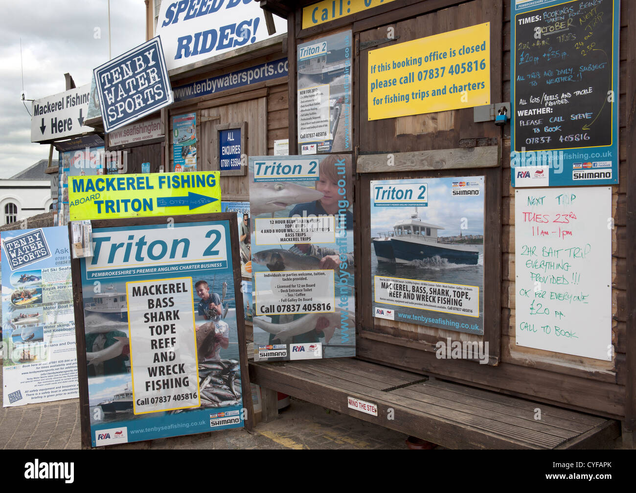 Booking offices and advertisements for boat trips, Tenby Harbour, Pembrokeshire, South Wales. Stock Photo