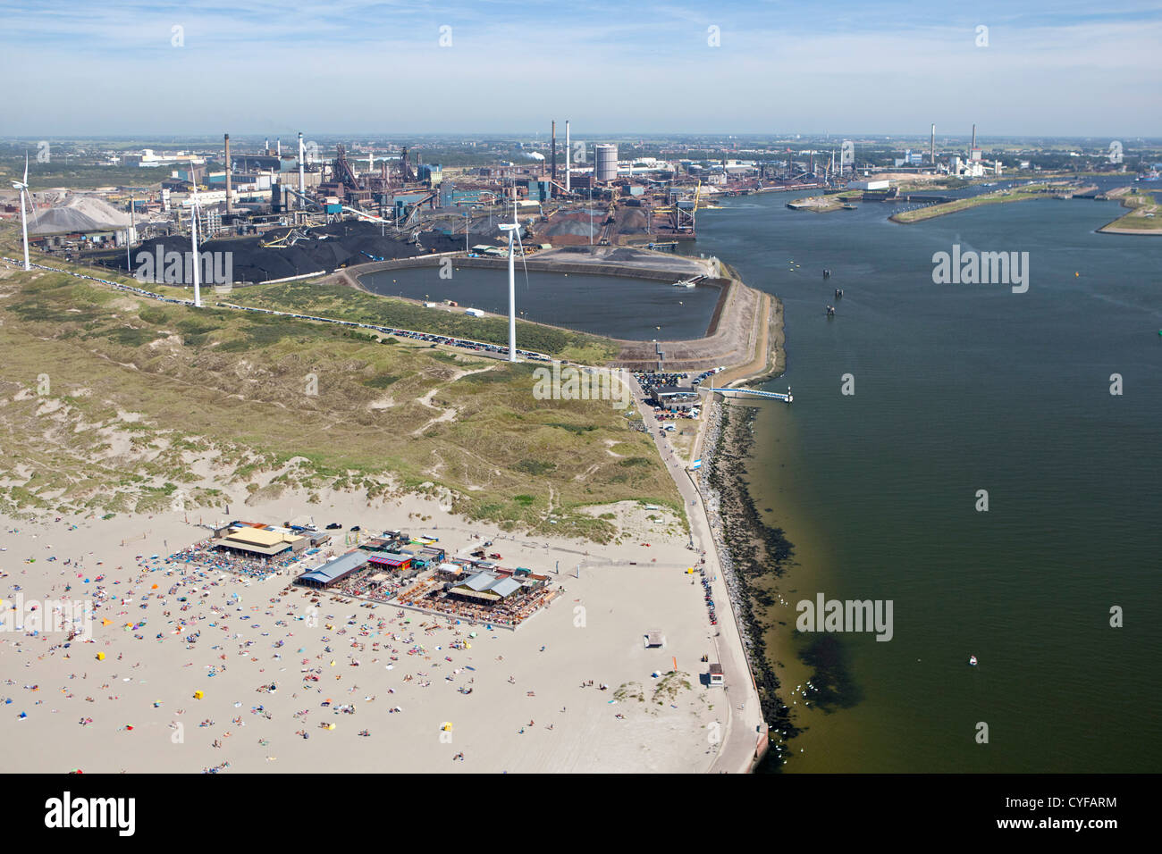 The Netherlands, Wijk aan Zee. People on beach. Background TATA Steel