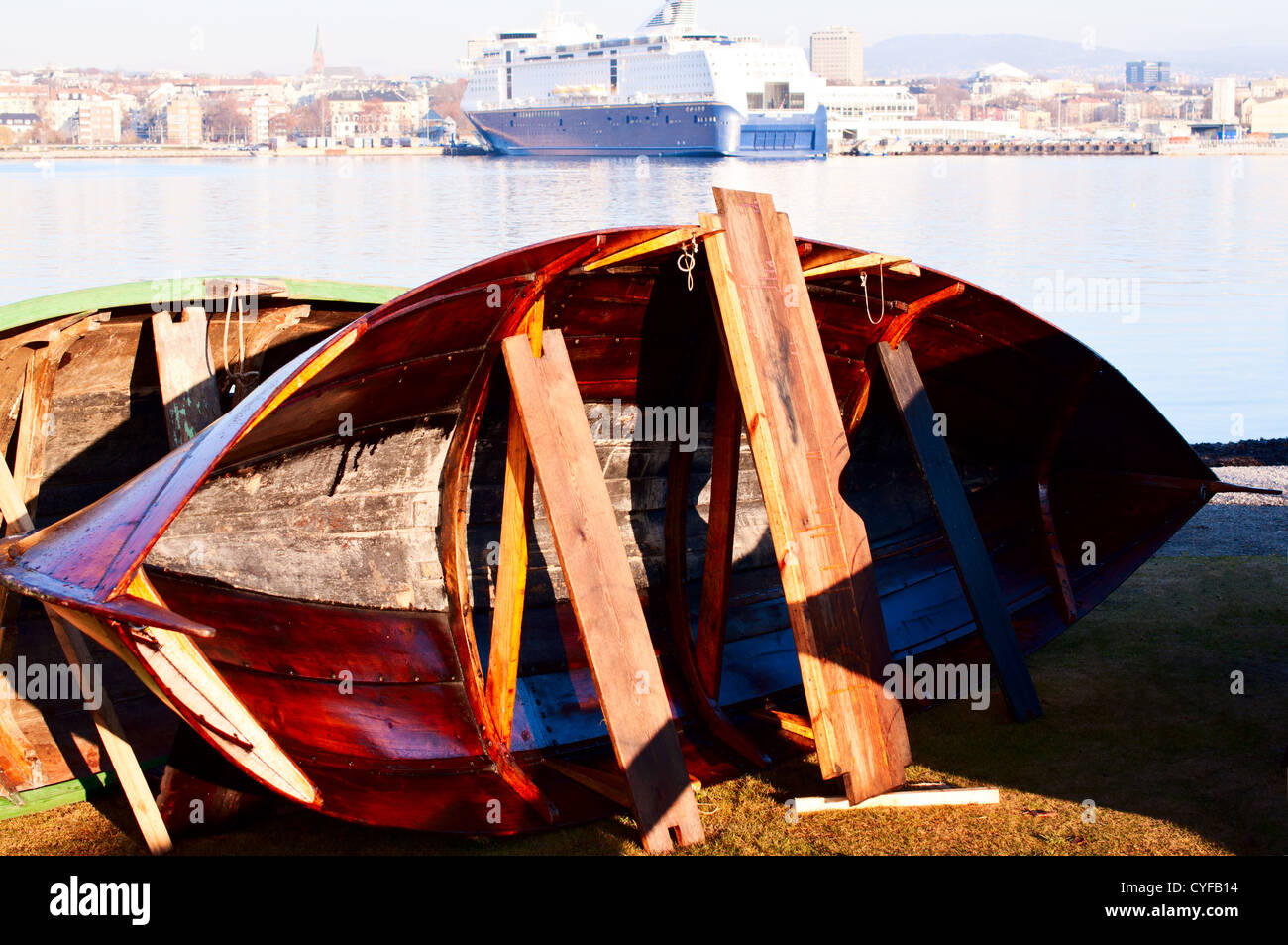 Wooden boat restoration with cruiser on background Stock Photo Alamy
