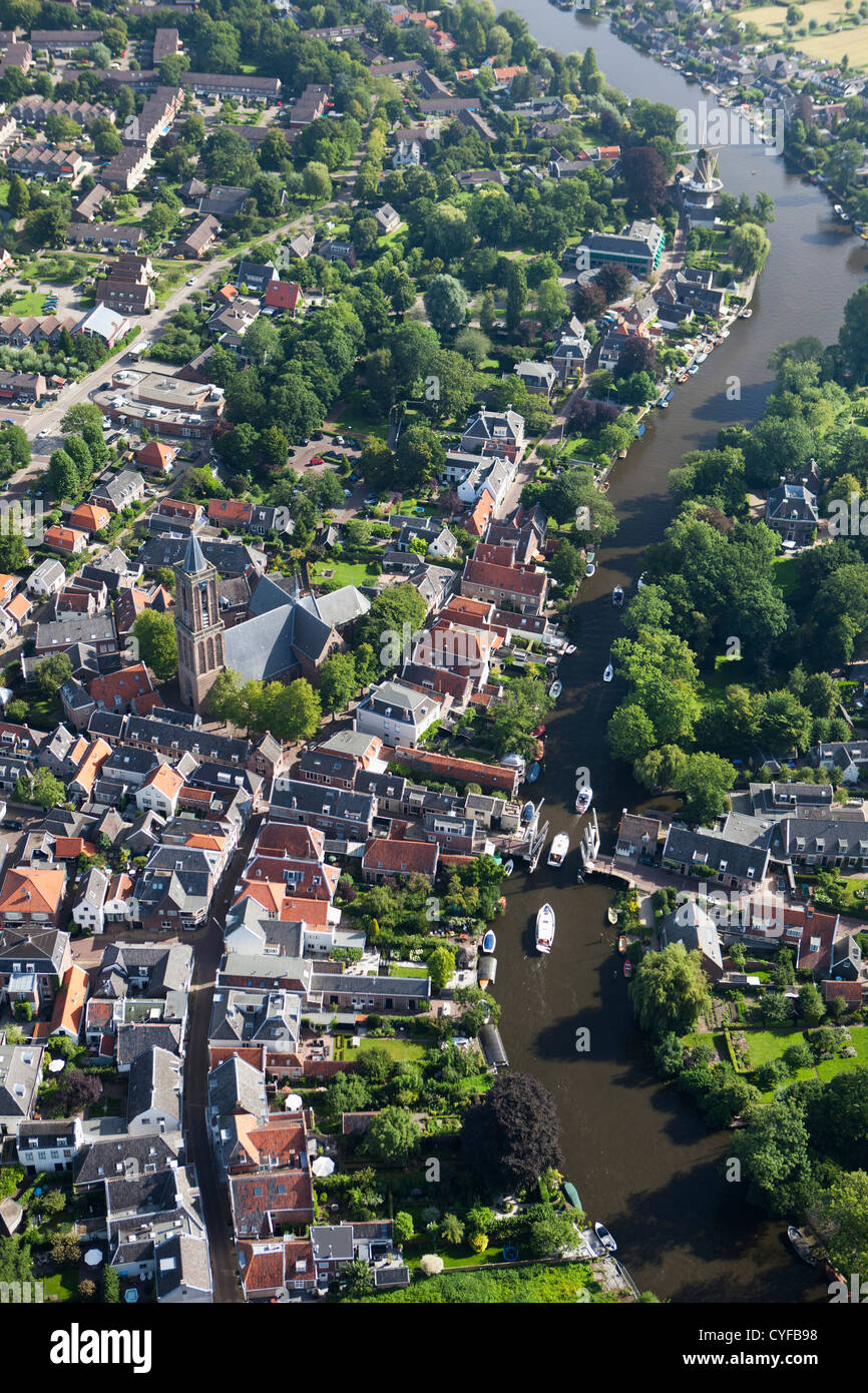 The Netherlands, Loenen aan de Vecht. River vecht. Boats passing drawbridge in center of village. Aerial. Stock Photo