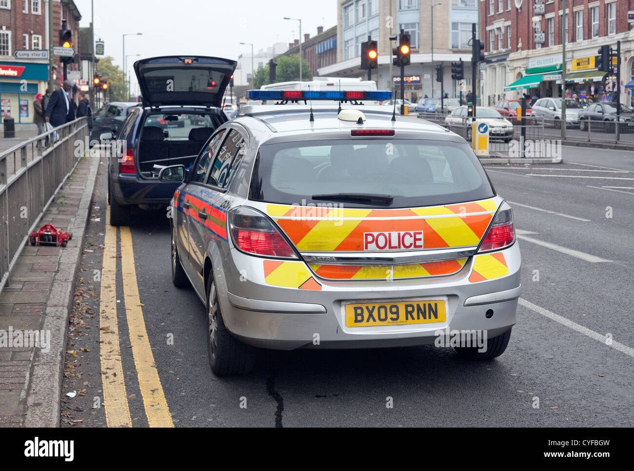 Police car checking on a broken down car, London, England, UK Stock ...