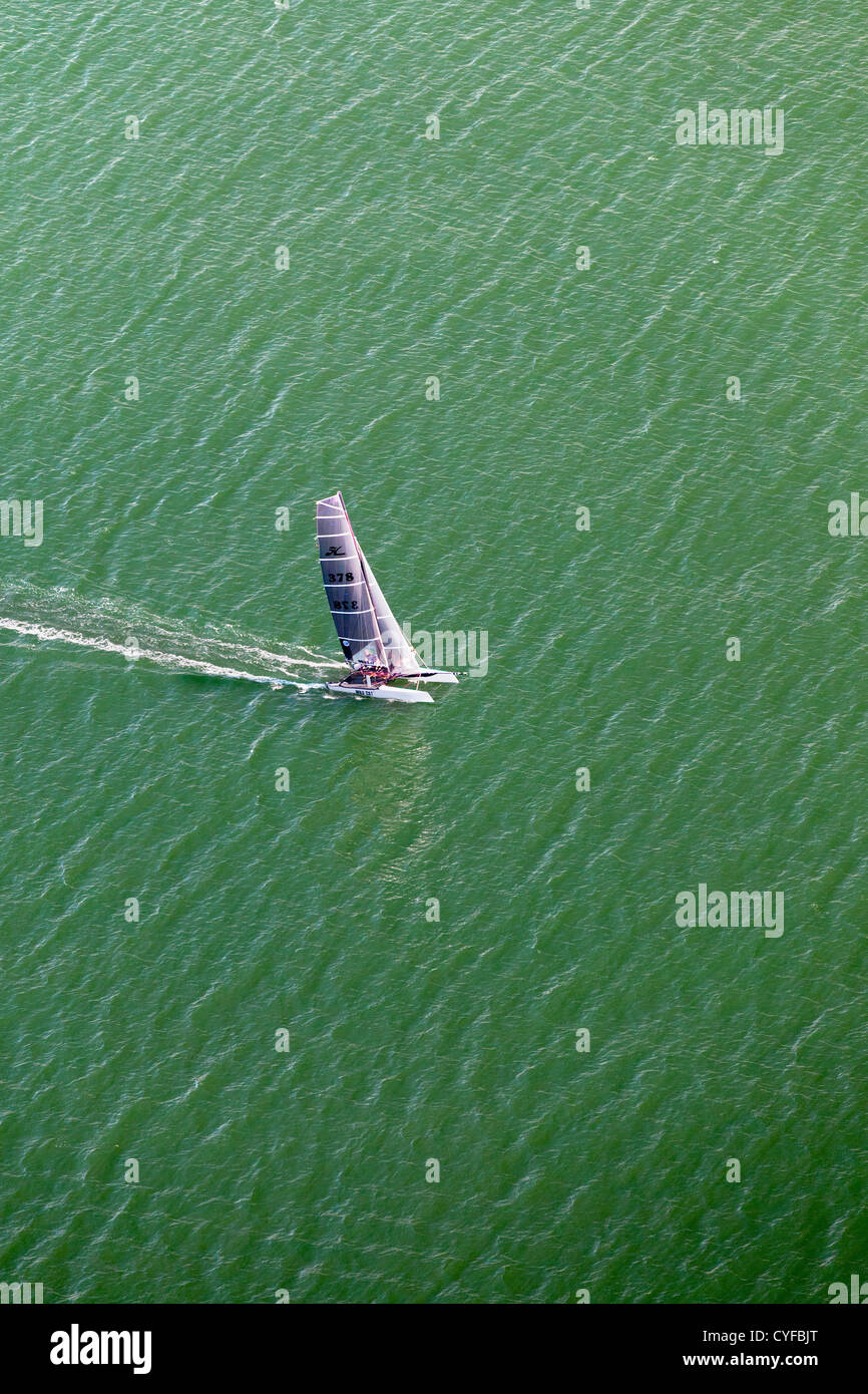 The Netherlands, Noordwijk. Catamaran sailing in North Sea. Aerial. Stock Photo