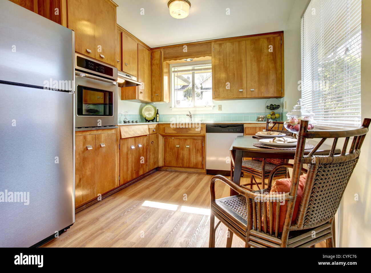 Cute old updated kitchen with blue tiles and new hardwood floor. Stock Photo
