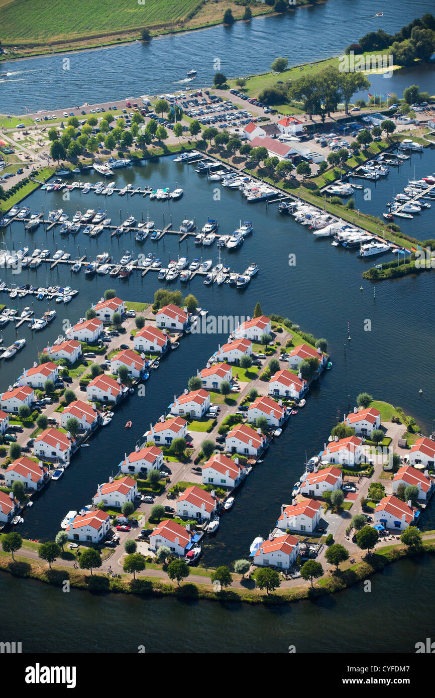 The Netherlands, Herten, Holiday houses and yachts in lakes called Maasplassen. Aerial. Stock Photo