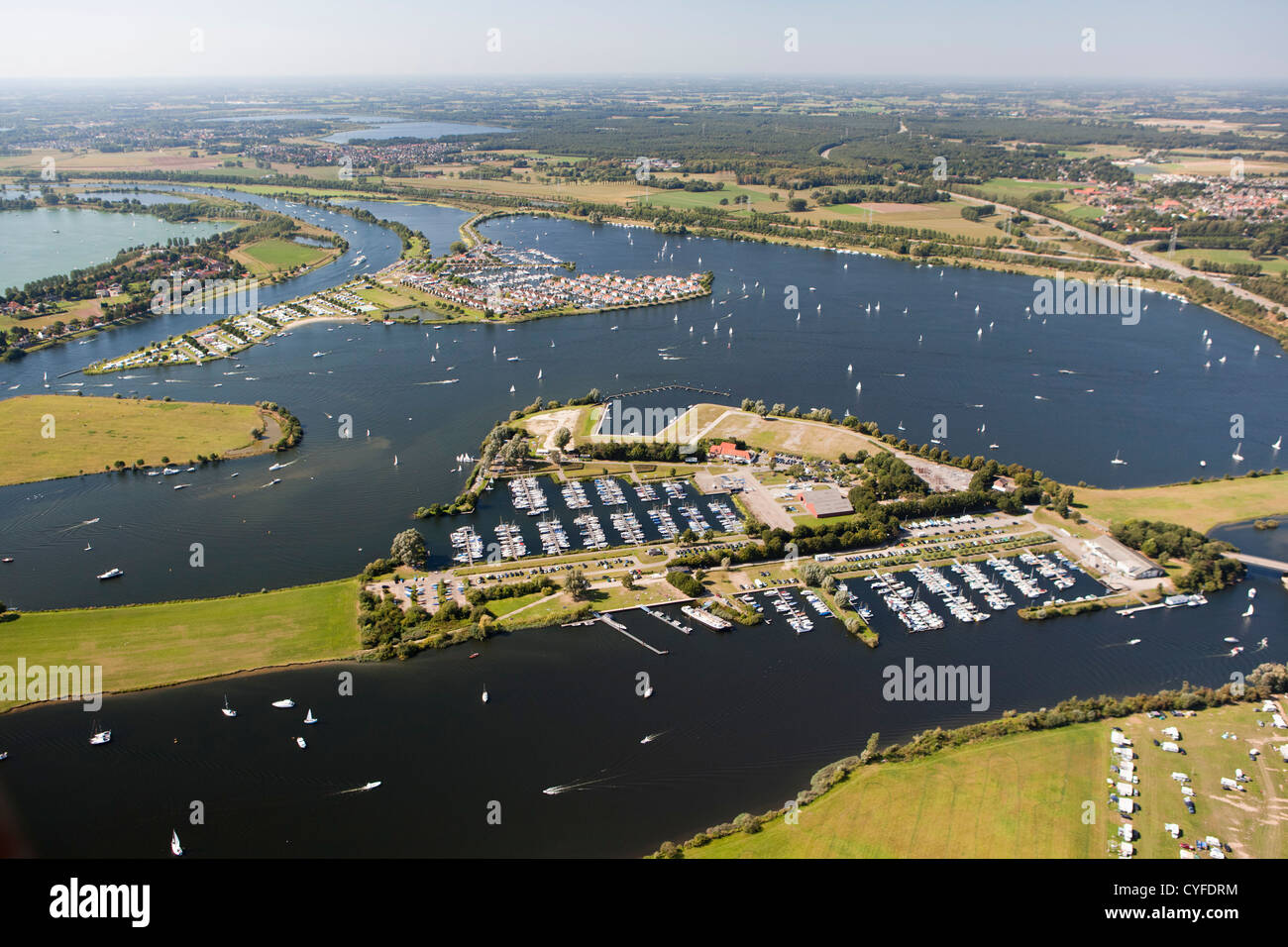 The Netherlands, Maasbracht, Holiday houses and yachts in lakes called Maasplassen. Aerial. Stock Photo