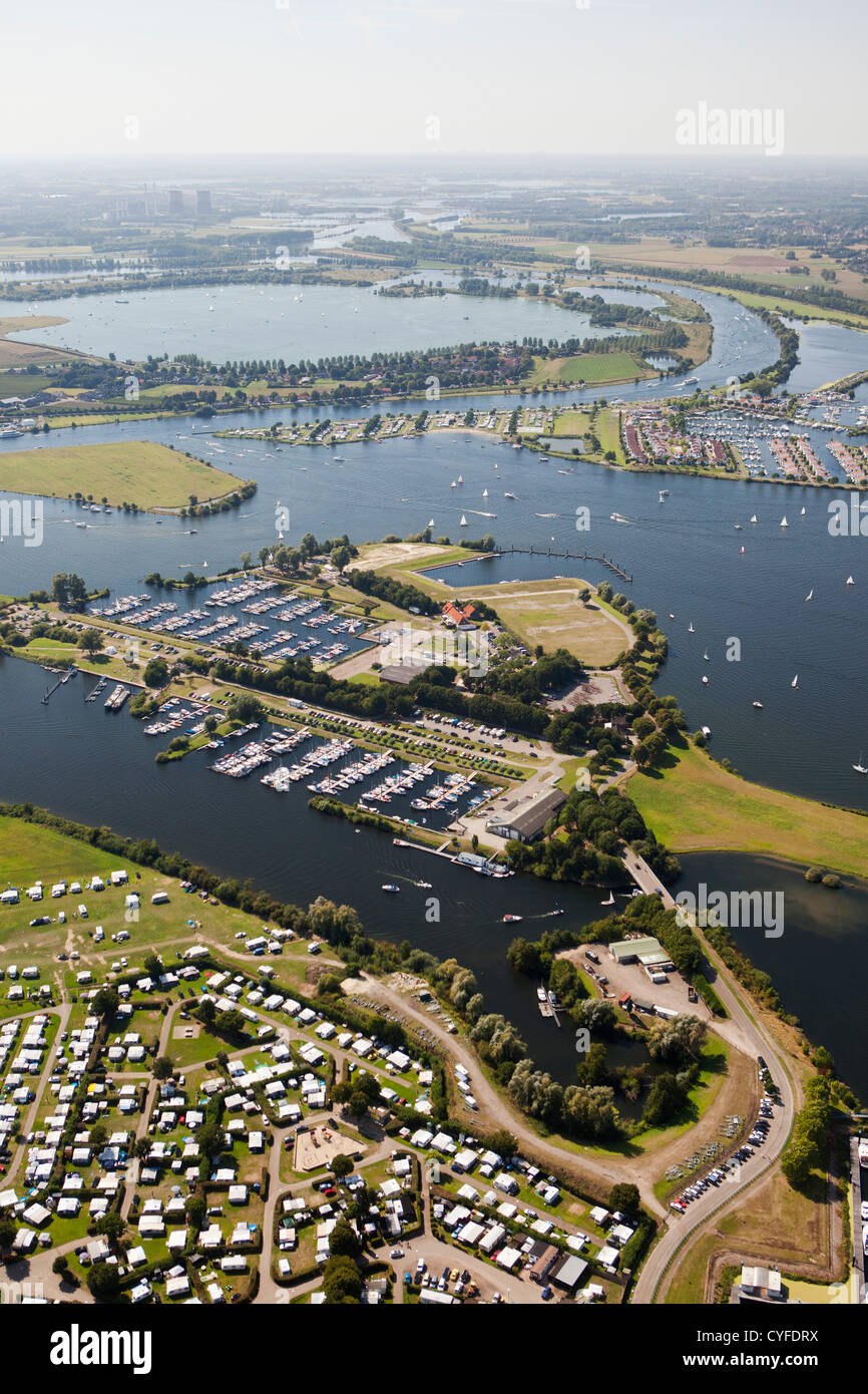 The Netherlands, Maasbracht, Holiday houses and yachts in lakes called Maasplassen. Aerial. Stock Photo