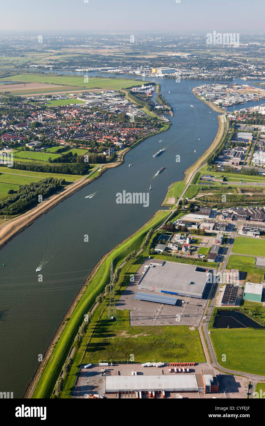 The Netherlands, Dordrecht, boats in river called Dordtse Kil. Left the village of 's-Gravendeel. Right industrial area. Aerial. Stock Photo