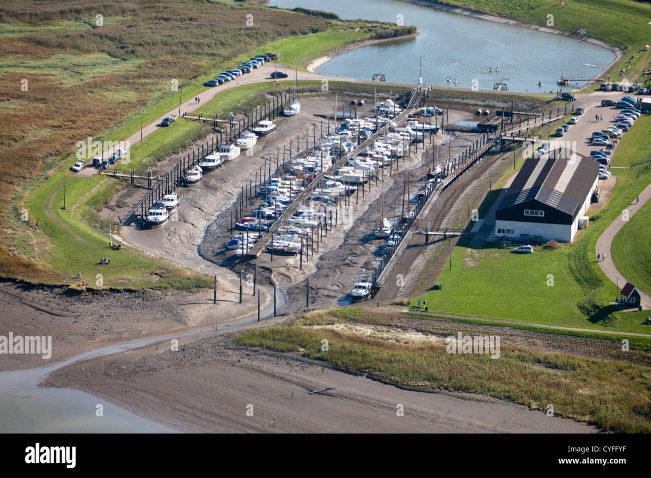 The Netherlands, Kloosterzande, Marina near Westerschelde river at low tide. Aerial. Stock Photo