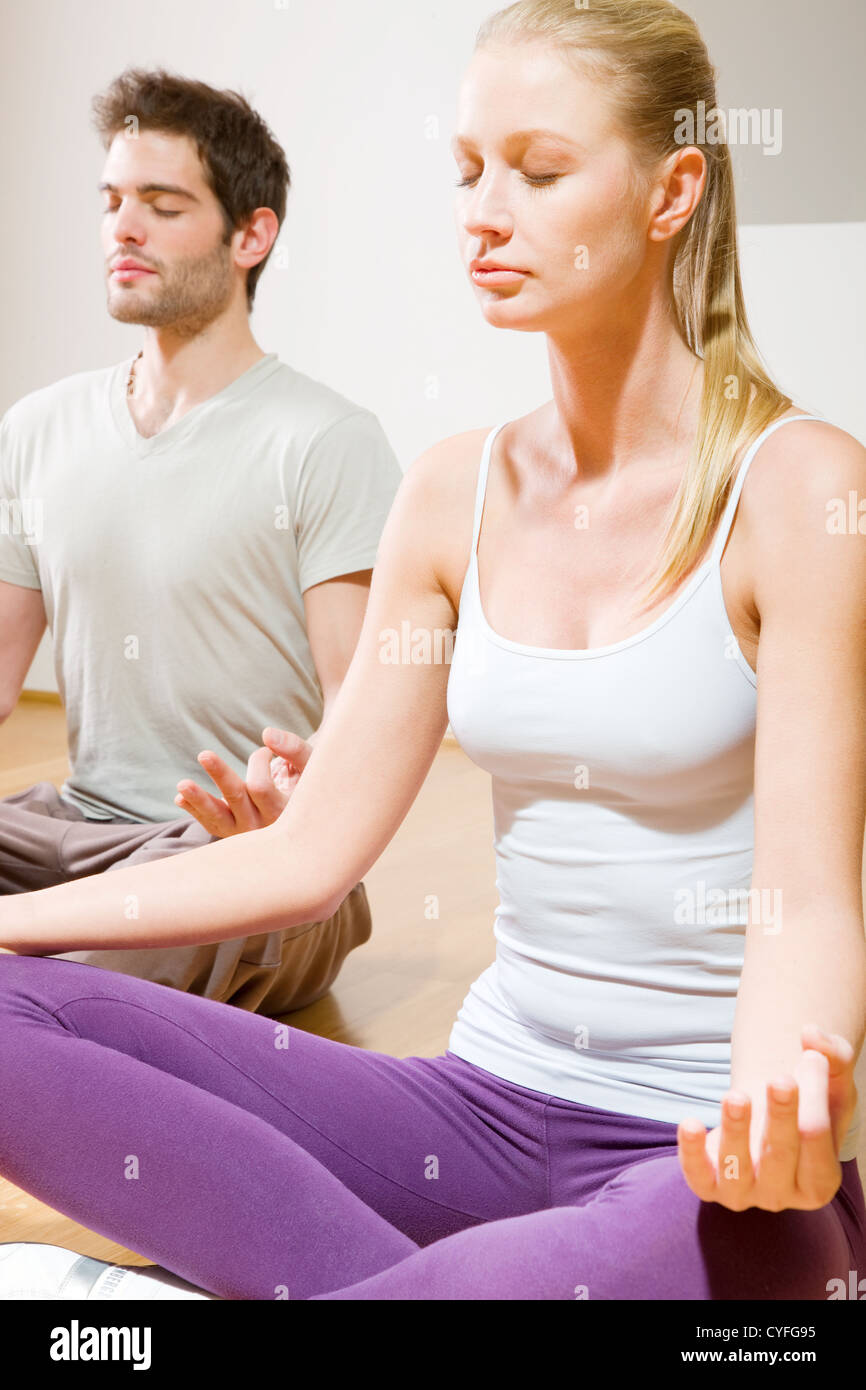 couple sitting on floor doing yoga Stock Photo