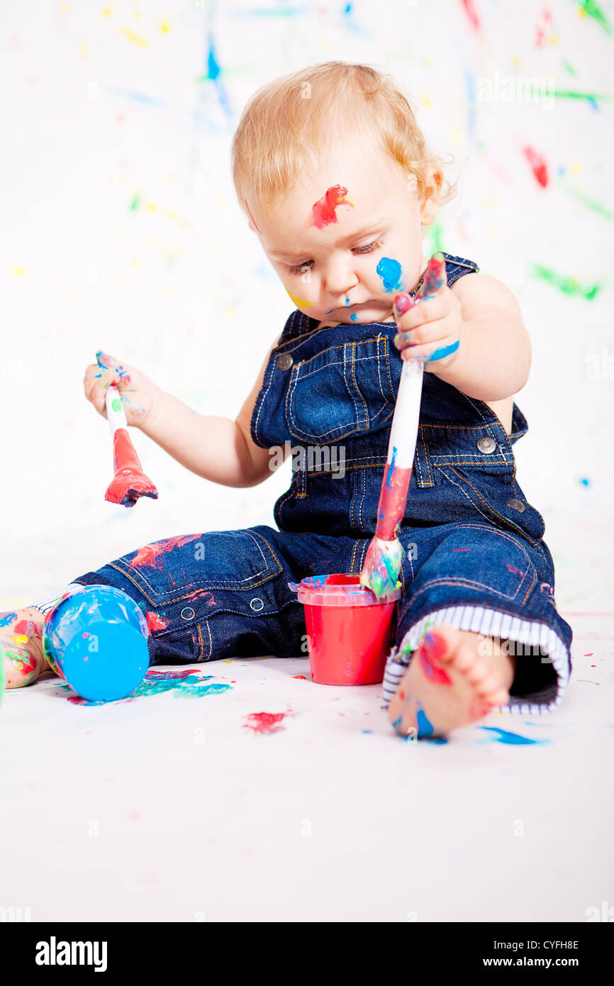 cute little baby painting and splatter with colours creativity on white ...