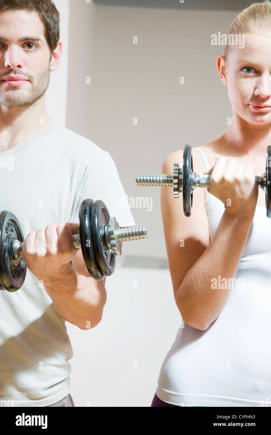 man and woman lifting dumbbell in gym Stock Photo - Alamy