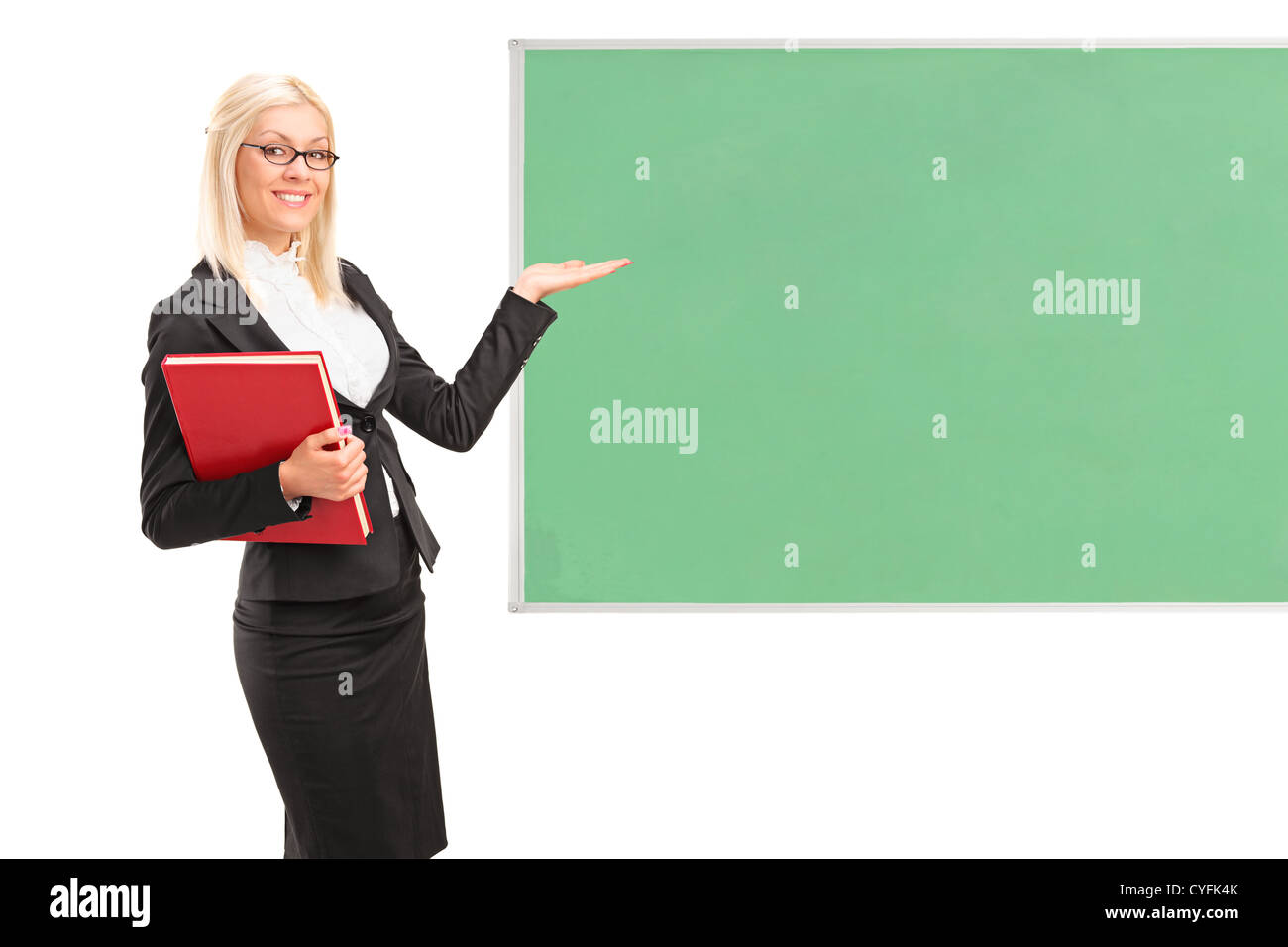 Young teacher holding a book and showing on a green board isolated on white background Stock Photo
