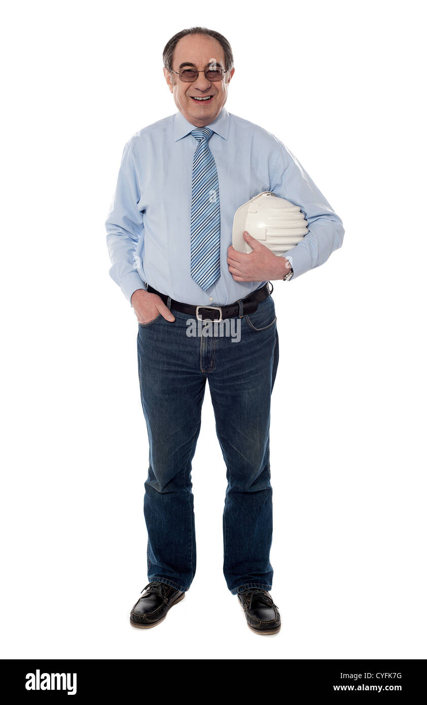 Senior architect holding helmet in one hand, full length view Stock Photo