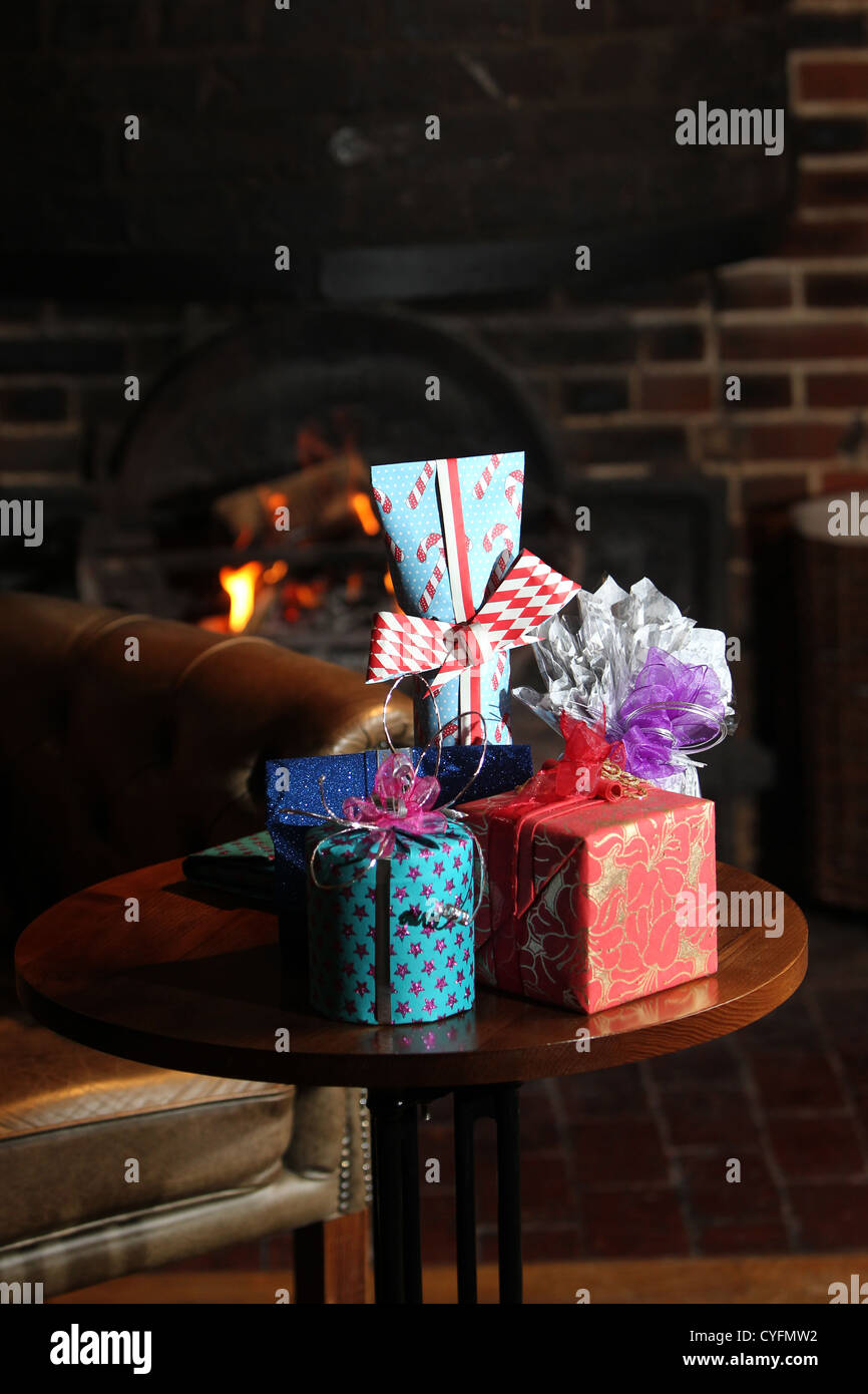 Presents in front of the fireplace in The Lamb pub in Angmering, Sussex, UK. Stock Photo