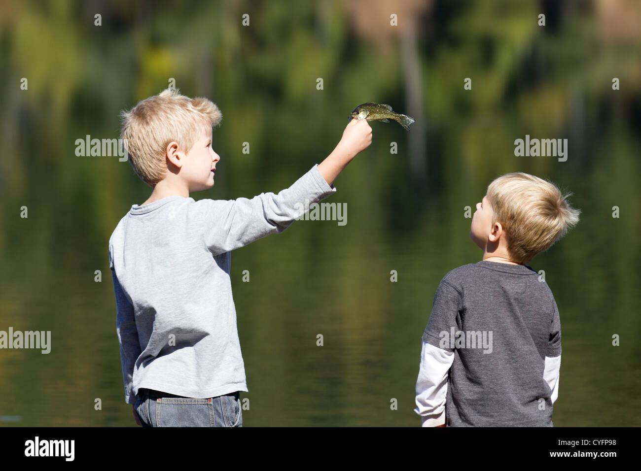 Two young blond boys fishing, Stock Photo