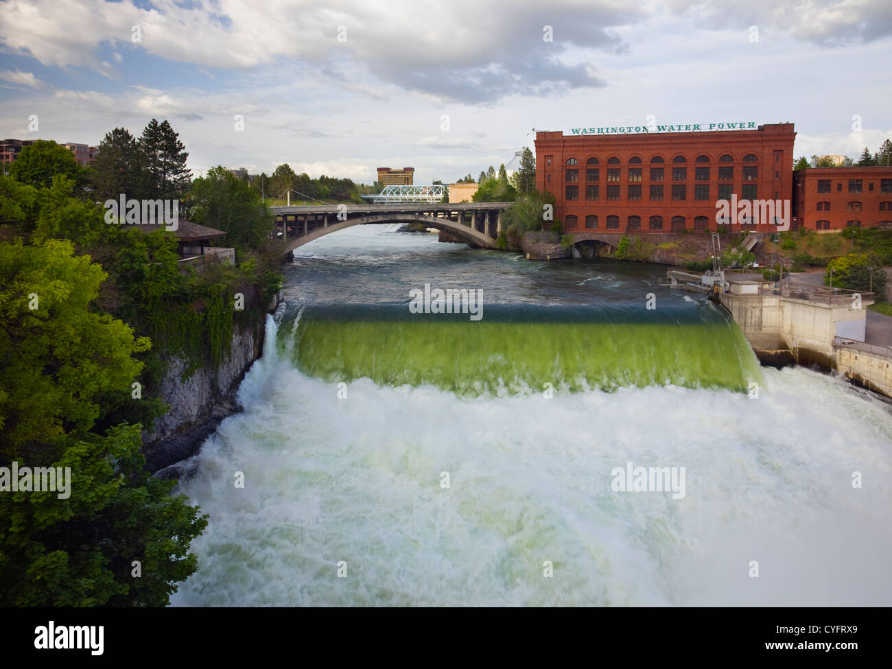WASHINGTON - The Spokane River thundering through Riverfront Park and pass the Washington Water Power plant in downtown Spokane. Stock Photo