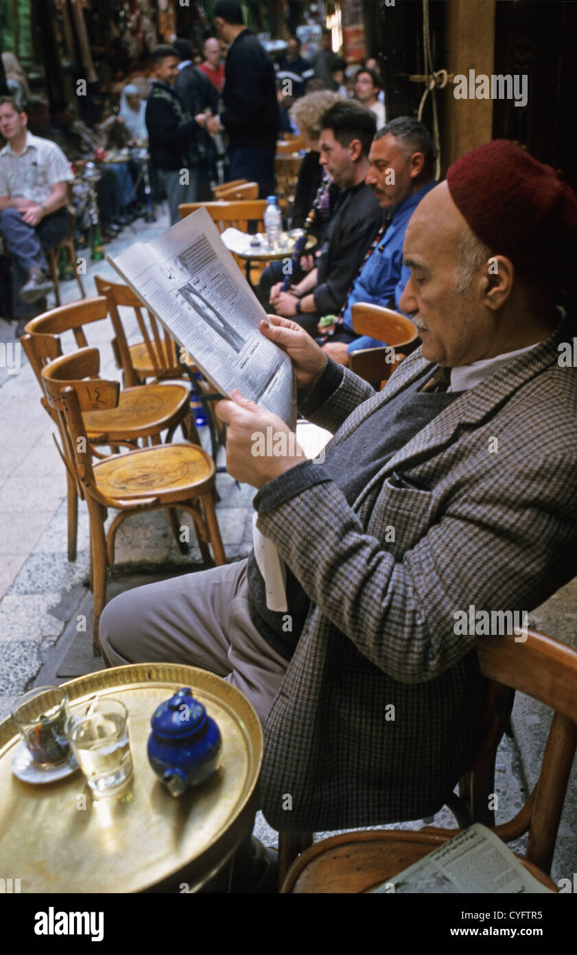 Egypt, Cairo, the great Bazaar of Khan al-Khalili. Famous coffeehouse: Fishawi. Man drinking tea and reading newspaper. Stock Photo