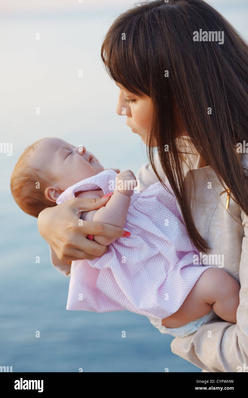Mother holding her infant baby Stock Photo