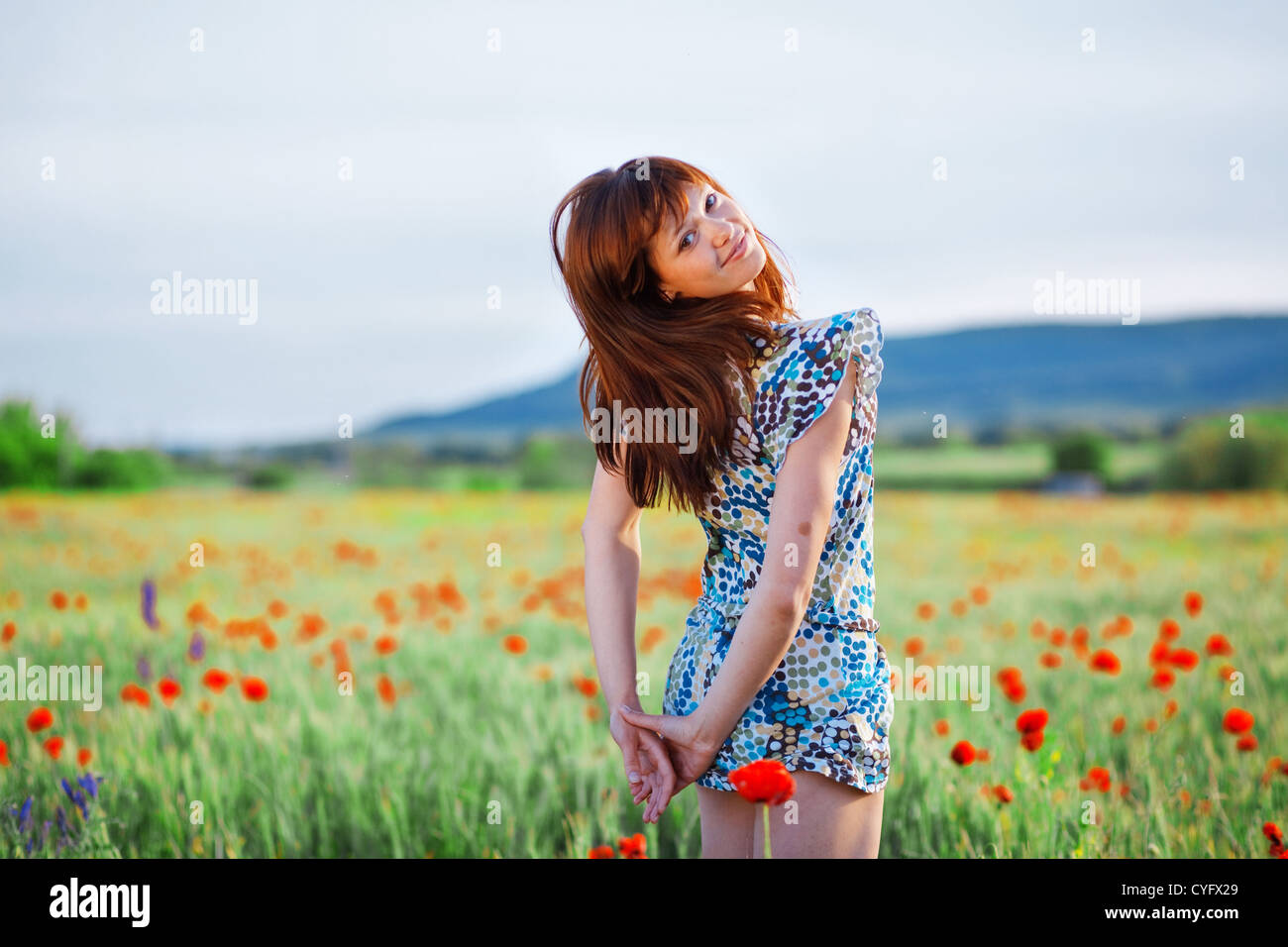 Beautiful smiling teenage girl posing in poppy field Stock Photo - Alamy