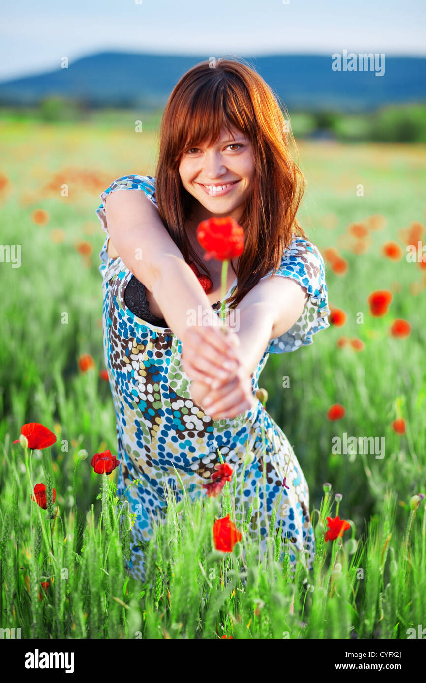 Beautiful smiling teenage girl giving flower to you Stock Photo Alamy