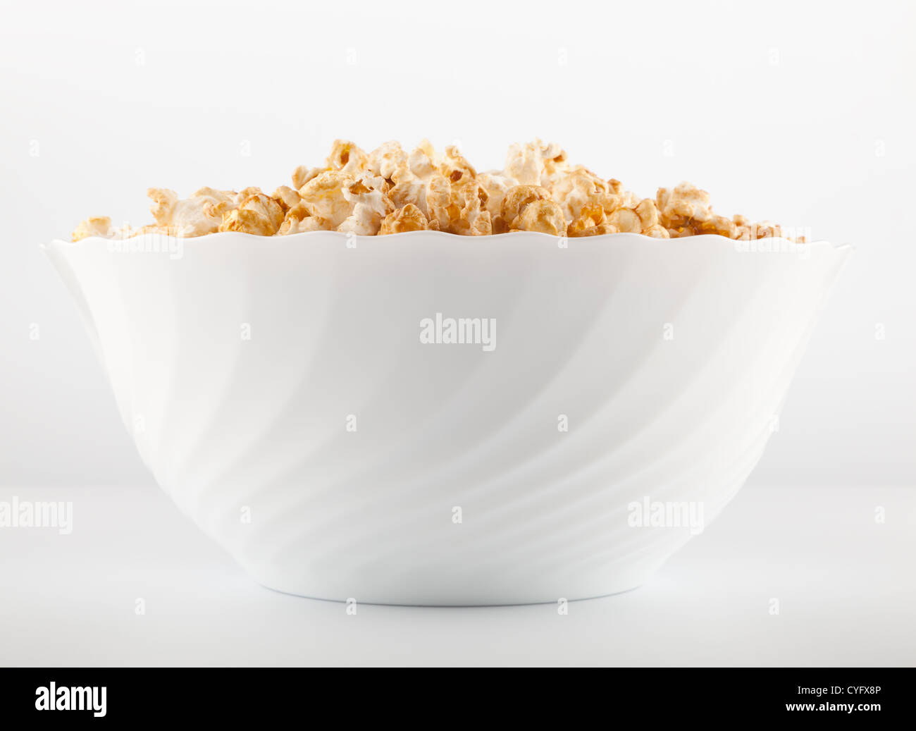 Big bowl of salty popcorn on light grey background Stock Photo