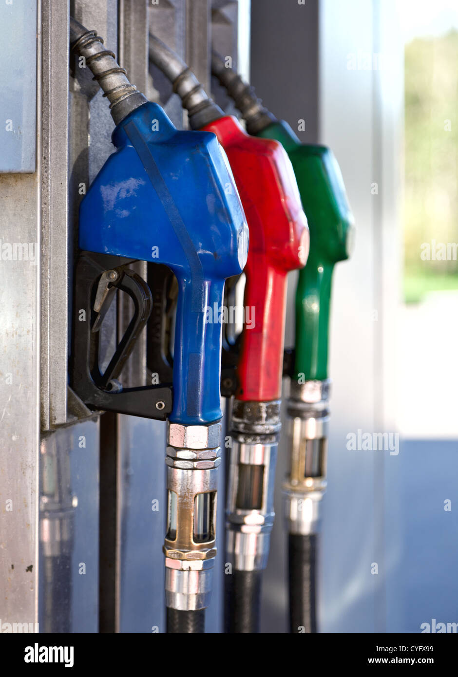 Three colorful pump nozzles at the gas station Stock Photo Alamy