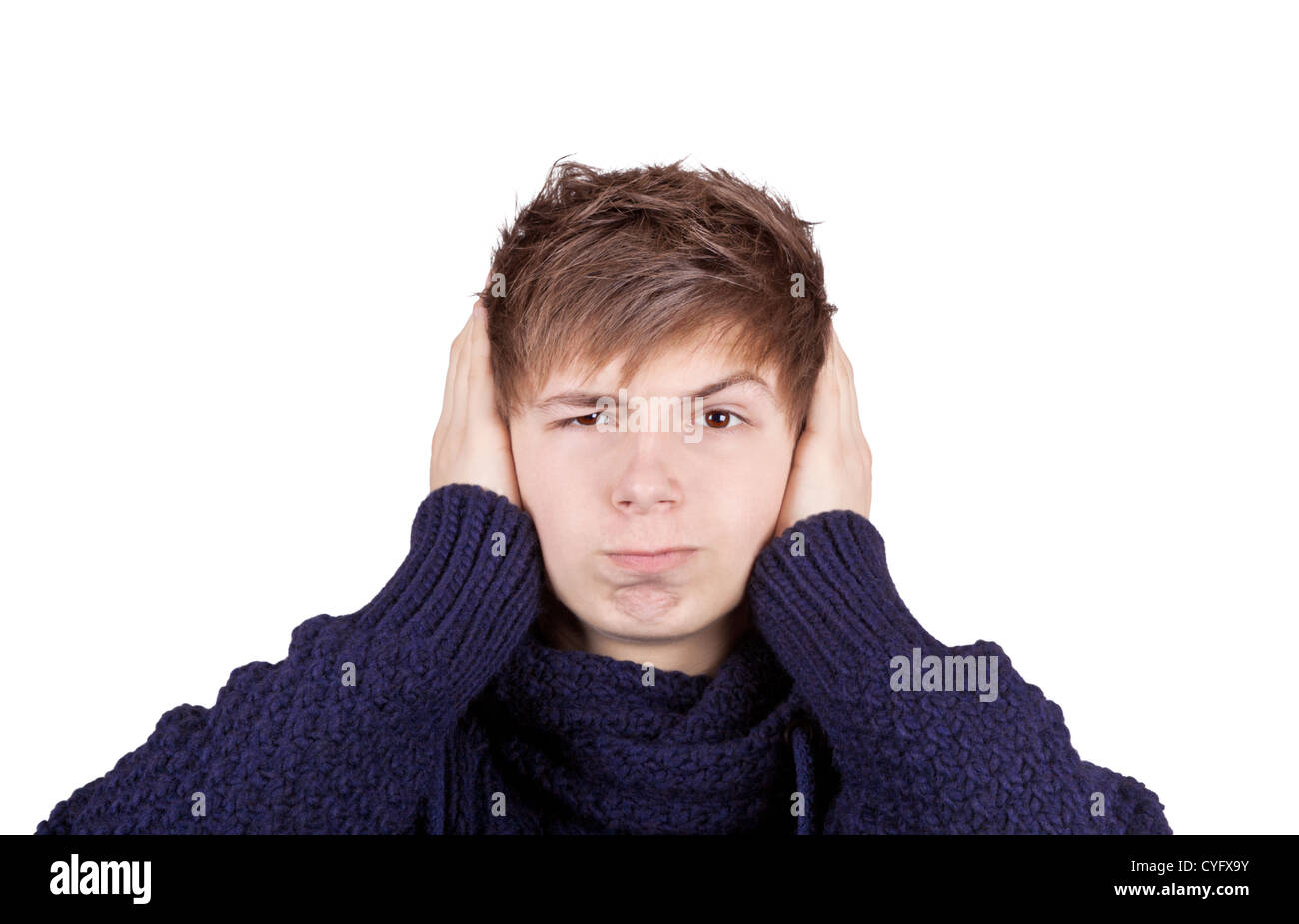 Teenager in a purple sweater shut his ears with his hands angrily Stock Photo