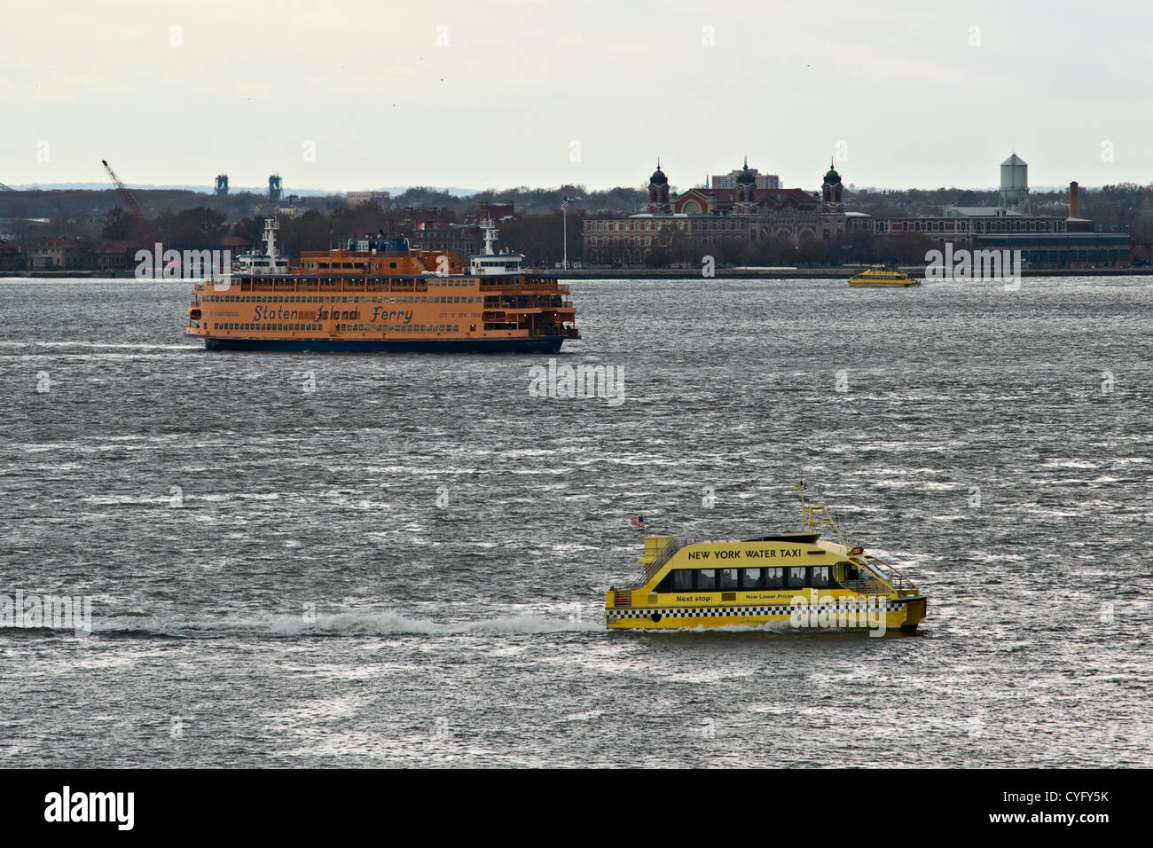 November 2, 2012, New York, NY, US.  A Staten Island Ferry moves between two New York Water Taxi boats.  Staten Island ferry service resumed between Staten Island and Manhattan, four days after Hurricane Sandy crippled New York's public transportation system. Stock Photo