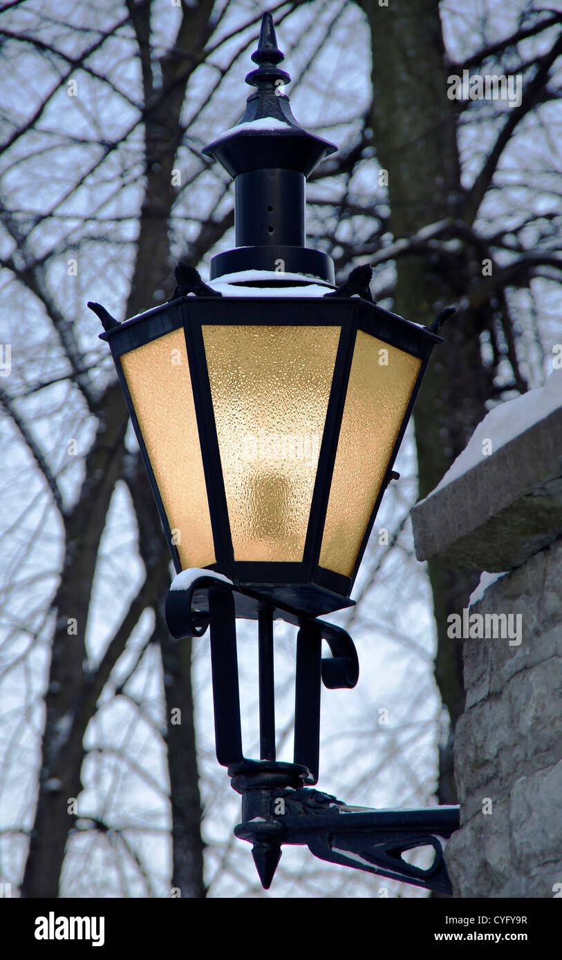 Classic black lantern with warm light at winter Stock Photo