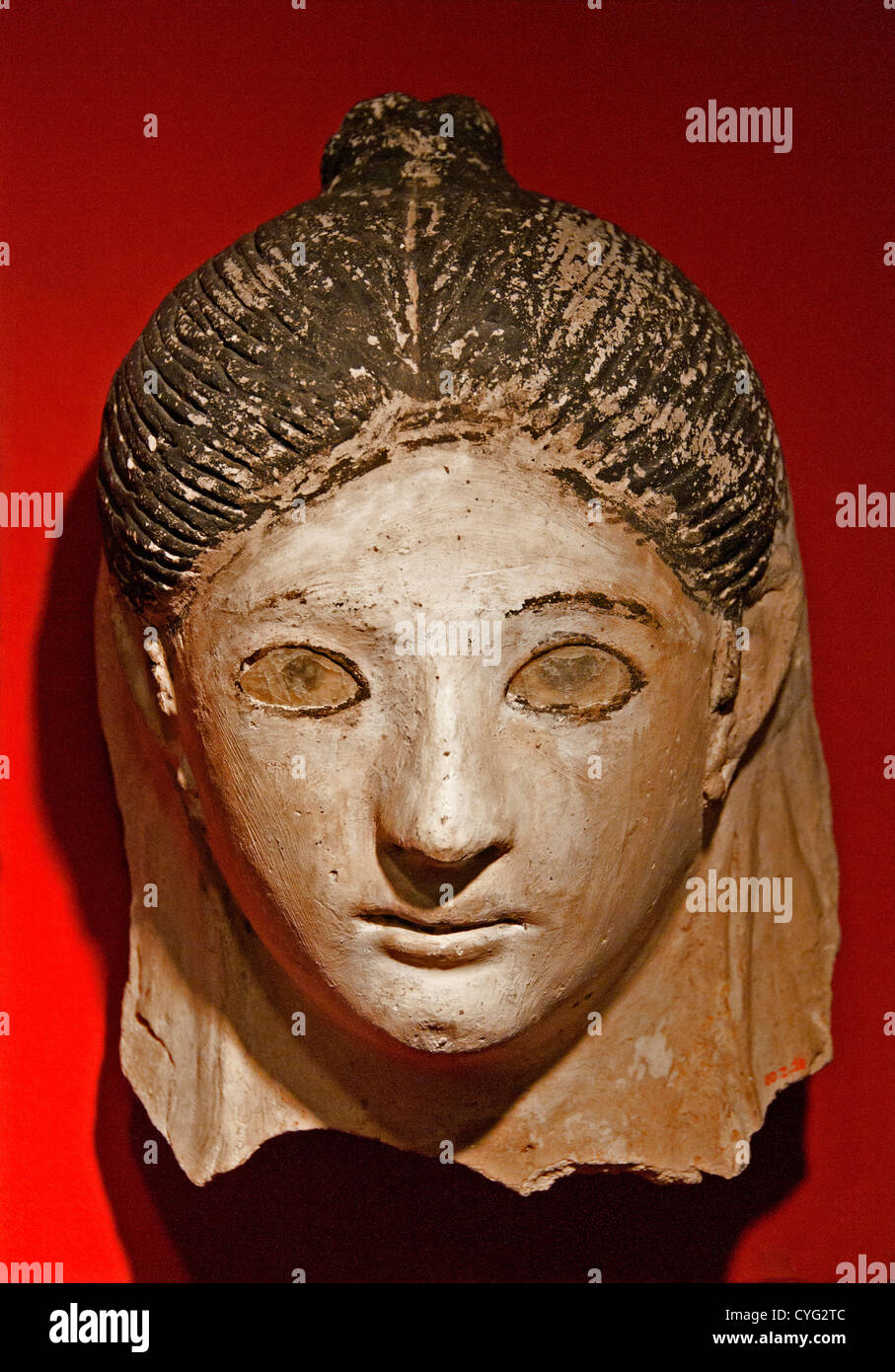 Mask of a woman with her hair in a small knot Roman AD 50 Egypt Plaster paint glass 17 cm Egyptian Female Stock Photo