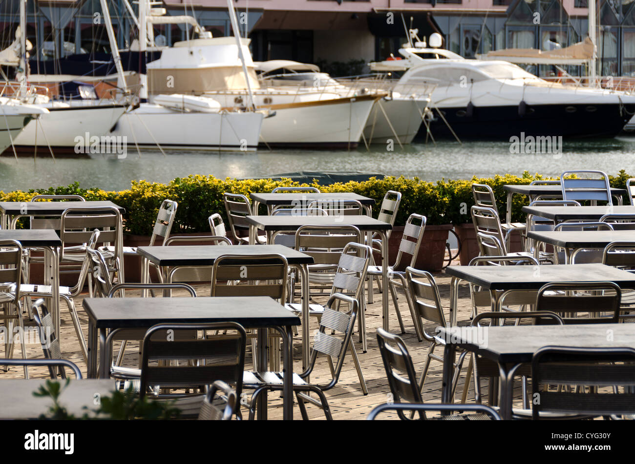 tables and chairs in a seaside restaurant in Genoa Stock Photo