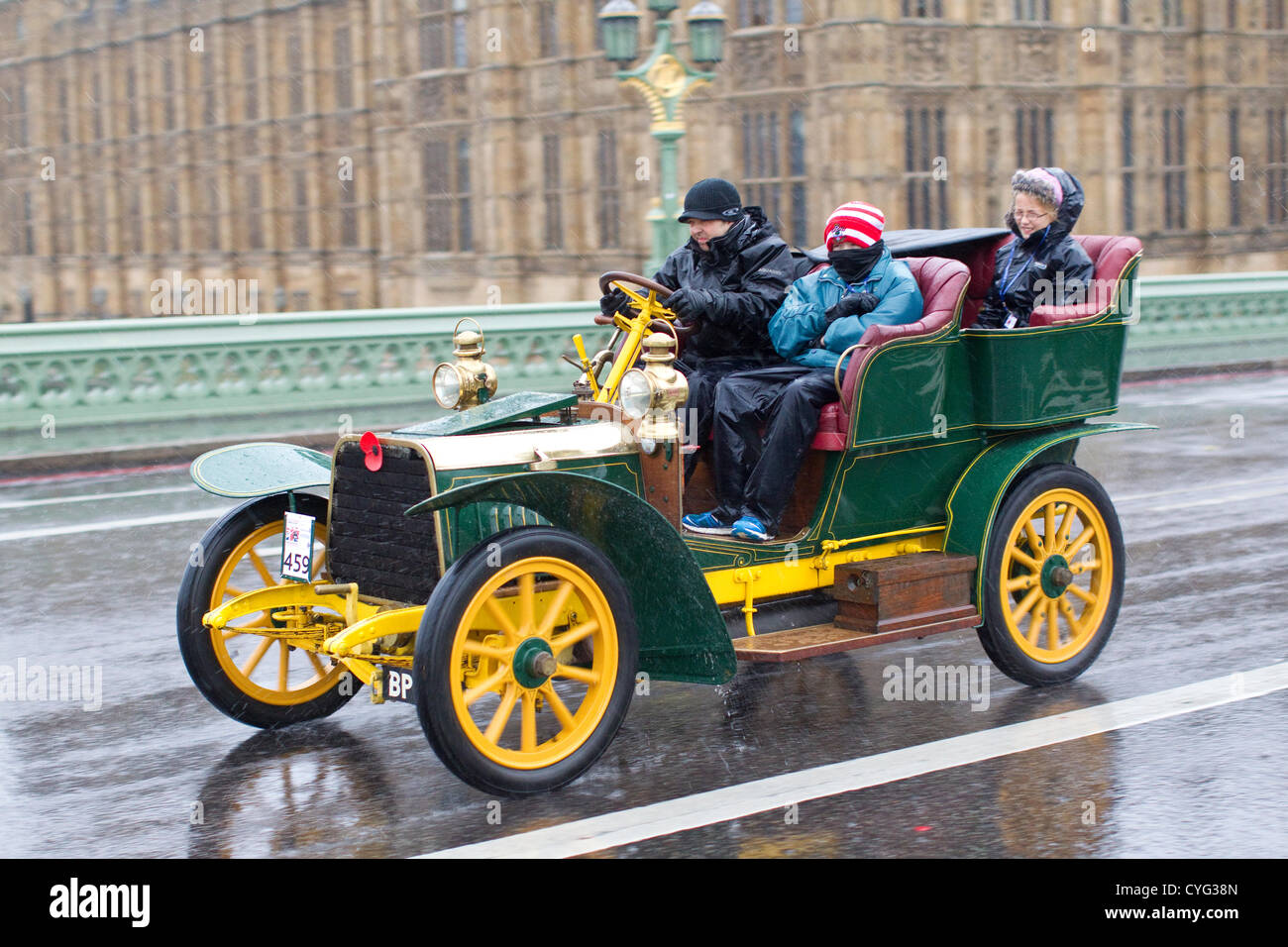Royal Automobile Club's annual Veteran Car Run London to Brighton. 04.11.2012 Picture shows No.459 a 1904 Darracq driven in wet conditions by Lawrie Smith crossing Westminster Bridge, one of many classic vehicles taking part in this years London to Brighton Veteran Car Run 2012 starting at Hyde Park in Central London and finishing at the seafront on the Sussex resort of Brighton. Stock Photo