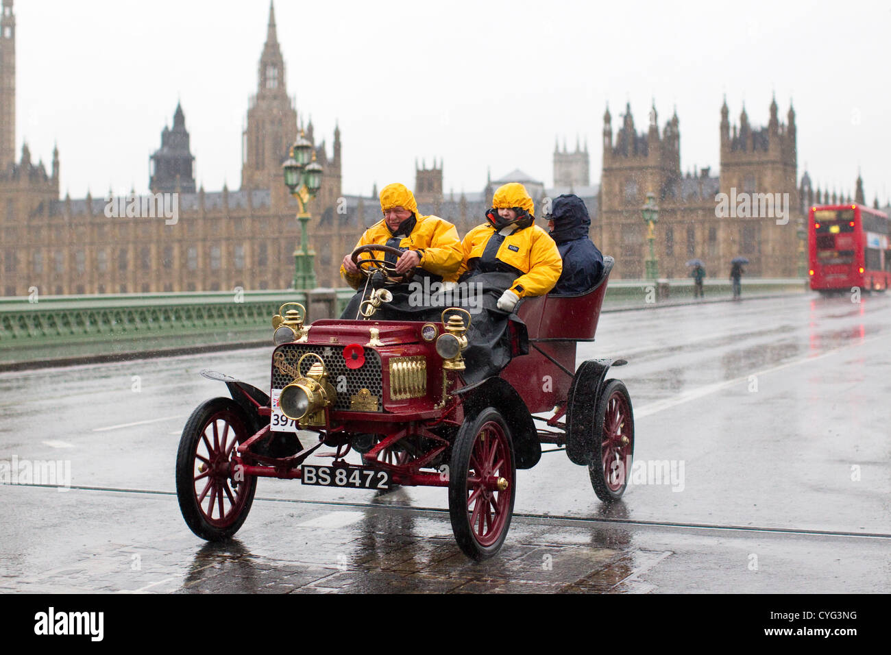 Royal Automobile Club's annual Veteran Car Run London to Brighton. 04.11.2012 Picture shows No.397 a 1904 Rambler driven in wet conditions by Alan Hollett crossing Westminster Bridge, one of many classic vehicles taking part in this years London to Brighton Veteran Car Run 2012 starting at Hyde Park in Central London and finishing at the seafront on the Sussex resort of Brighton. Stock Photo
