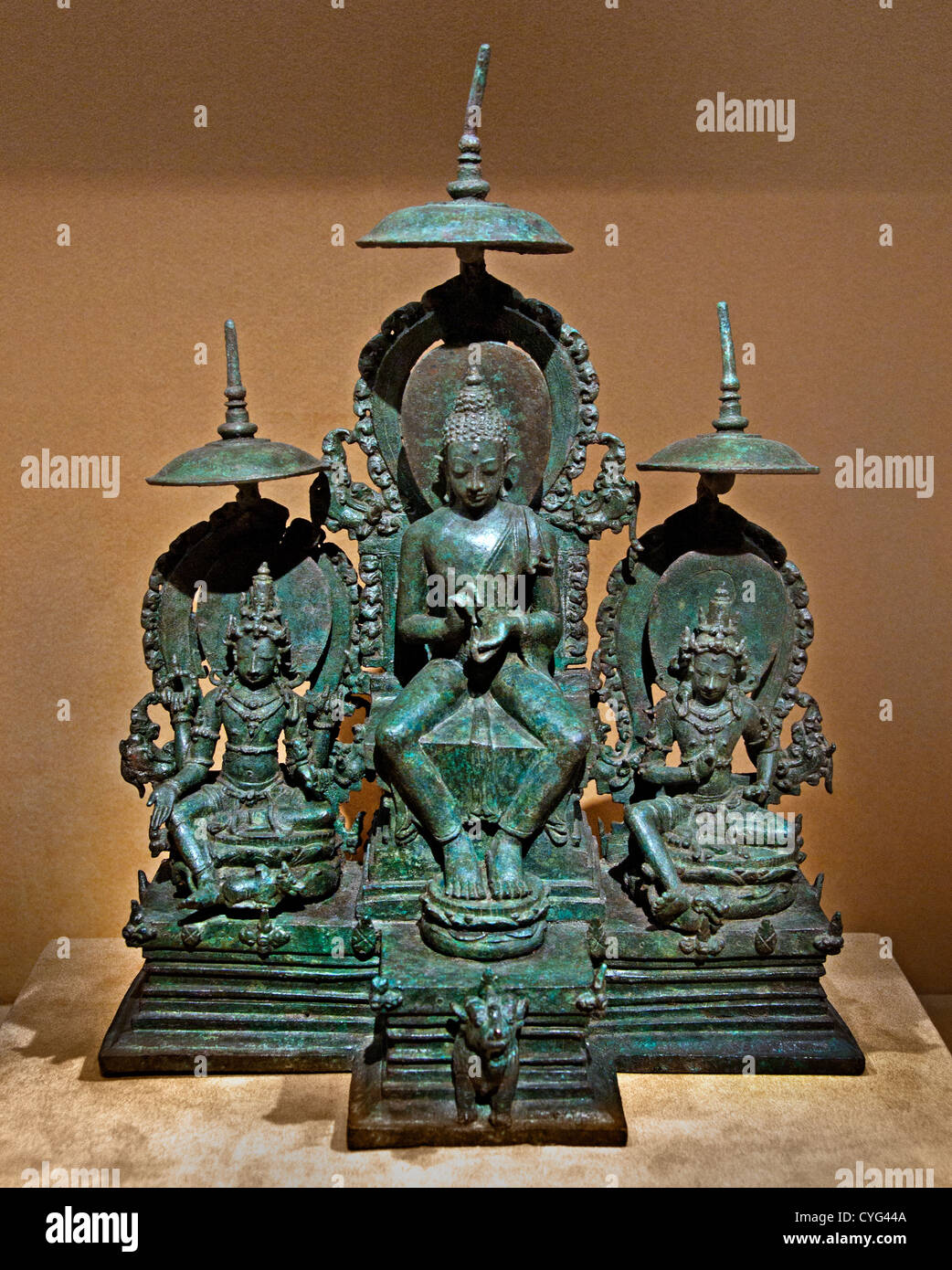 Enthroned Buddha Attended by the Bodhisattvas Avalokiteshvara and Vajrapani Javanese 10th century Indonesia Java Bronze 29 cm Stock Photo