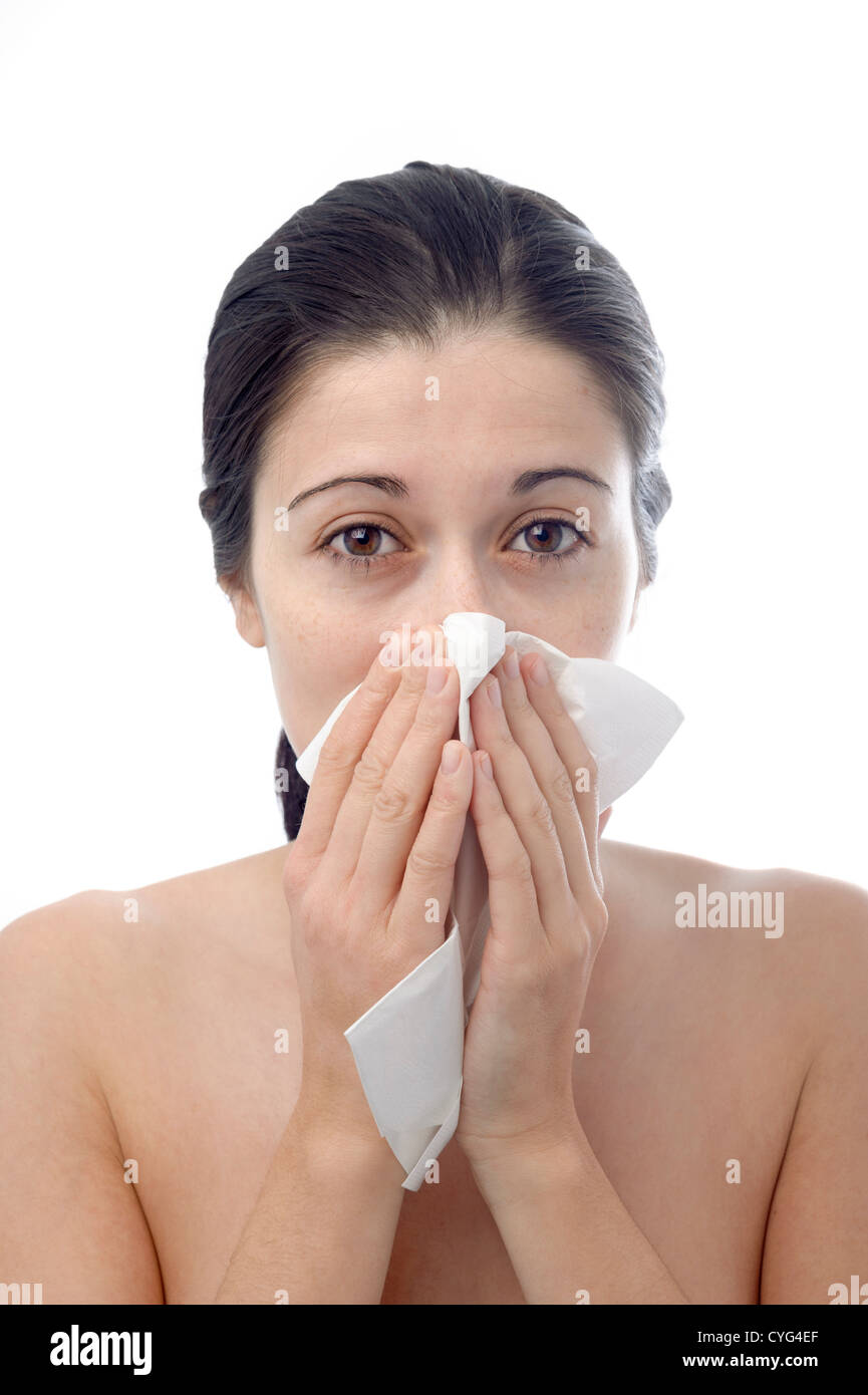 Young woman blowing her nose with tissue paper Stock Photo Alamy