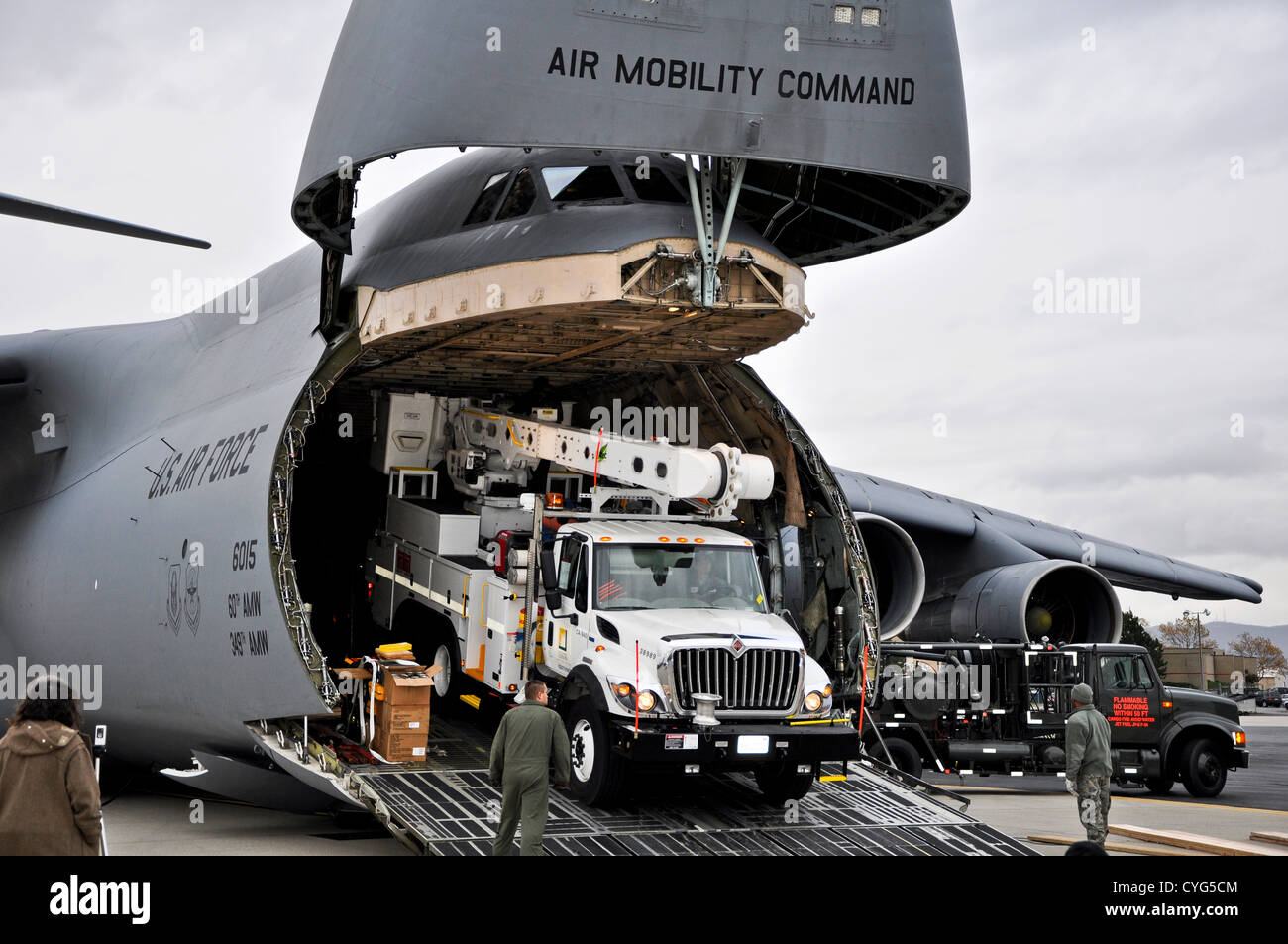 US Air Force airmen unload power repair equipment belonging to Southern California Edison from a C-5 Galaxy aircraft at Stewart Air National Guard Base November 1, 2012 in Newburgh, N.Y. The Department of Defense initiated the airlift operation to aid recovery efforts in Hurricane Sandy's aftermath. Stock Photo
