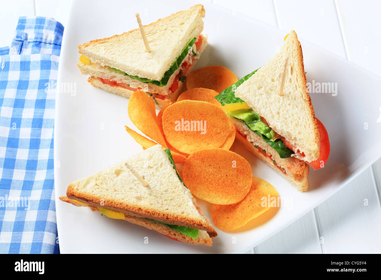 Vegetable sandwich triangles and spicy crisps Stock Photo