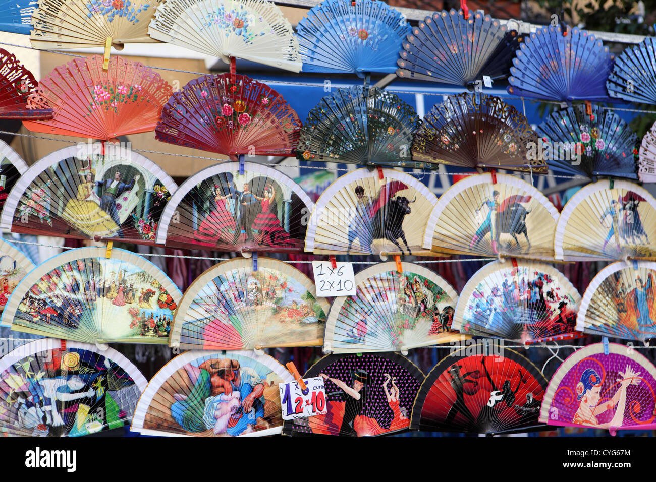 Selection of souvenir Spanish fans for sale, street market pavement stall, El Rastro, Madrid, Spain. Stock Photo