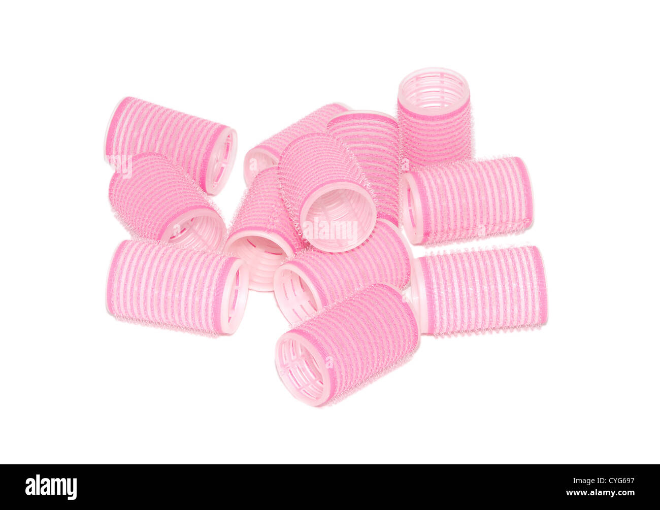 Twelve pink velcro rollers in a jumbled pile, isolated on a white background Stock Photo