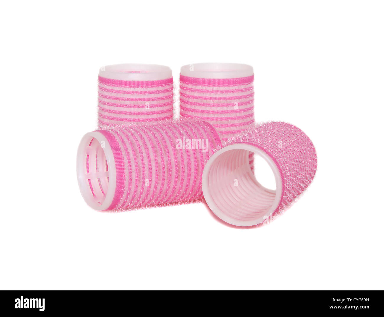 Four velcro rollers: two standing, two lying on their side, isolated on a white background Stock Photo