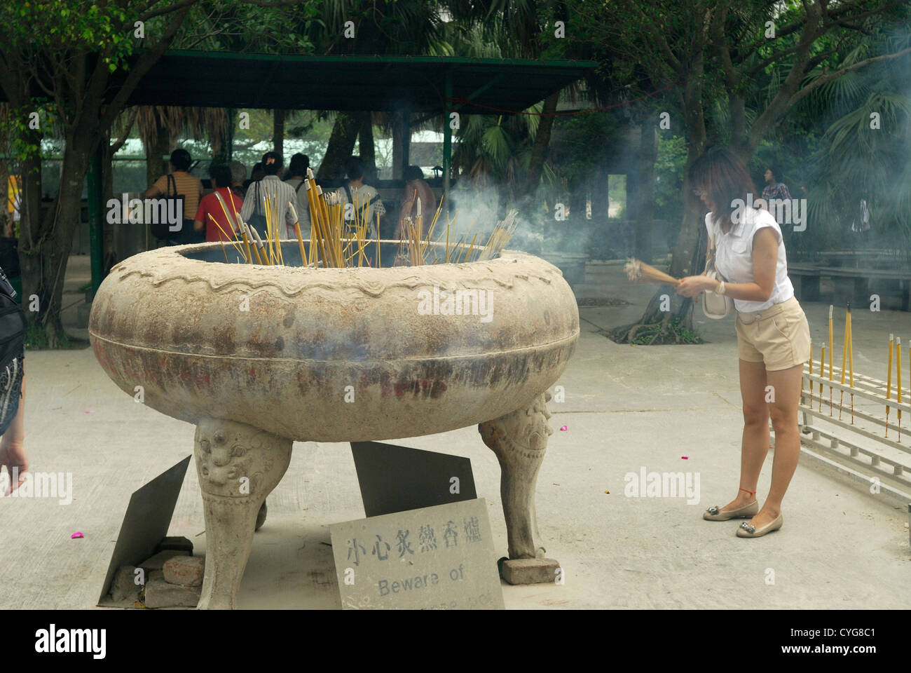 Buddhist ritual of Incense offerings placed in a censer at the entrance