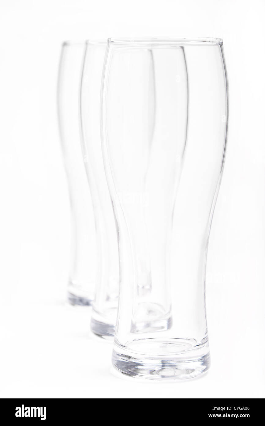 three empty beer glasses in vertical white background Stock Photo Alamy